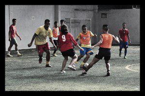 street_soccer_world_cup_kids_plaing_red_orange_soccer_ball_vest_goal_fun_children_somebody_photo__opt